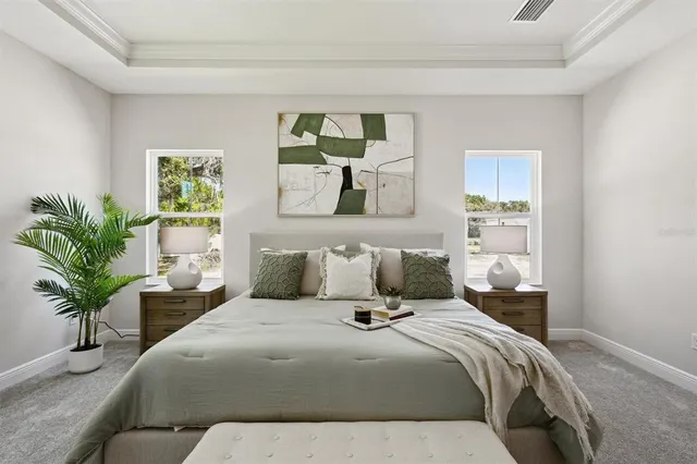 a bedroom with a bed and a potted plant