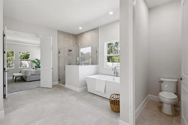 a bathroom with a toilet a tub and a shower