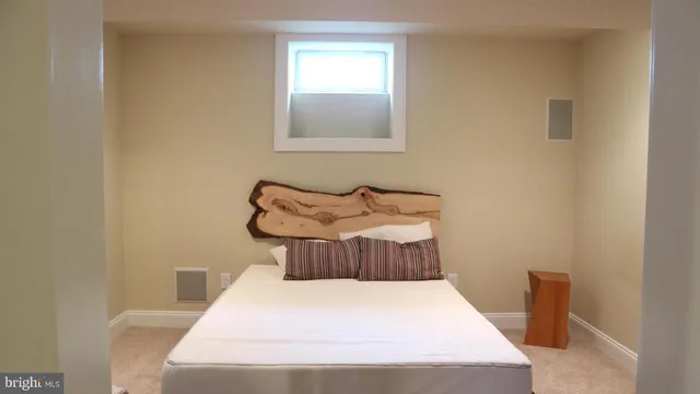 a bedroom with a bed and window