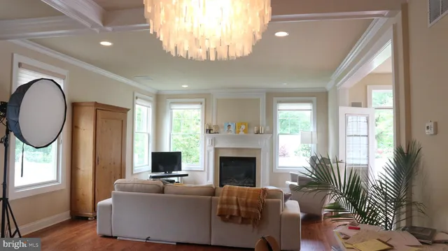 a living room with furniture a large window and a fireplace
