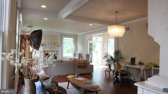 a living room with furniture and a chandelier