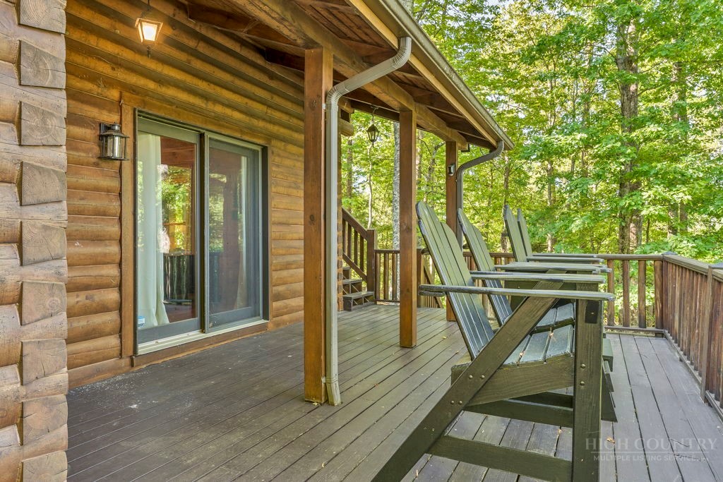 2229 Elk Ridge Road Ferguson, NC 28624 - Photo 18 of 42 a view of a balcony with wooden floor and outdoor seating