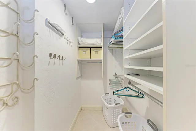 a room with a white cabinet and a shower curtain
