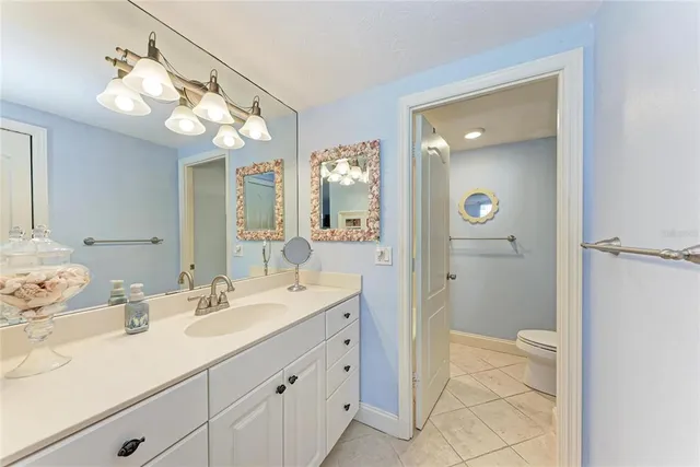 a bathroom with a sink vanity and a mirror