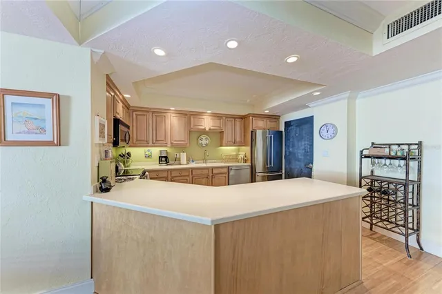 a large kitchen with a table and chairs