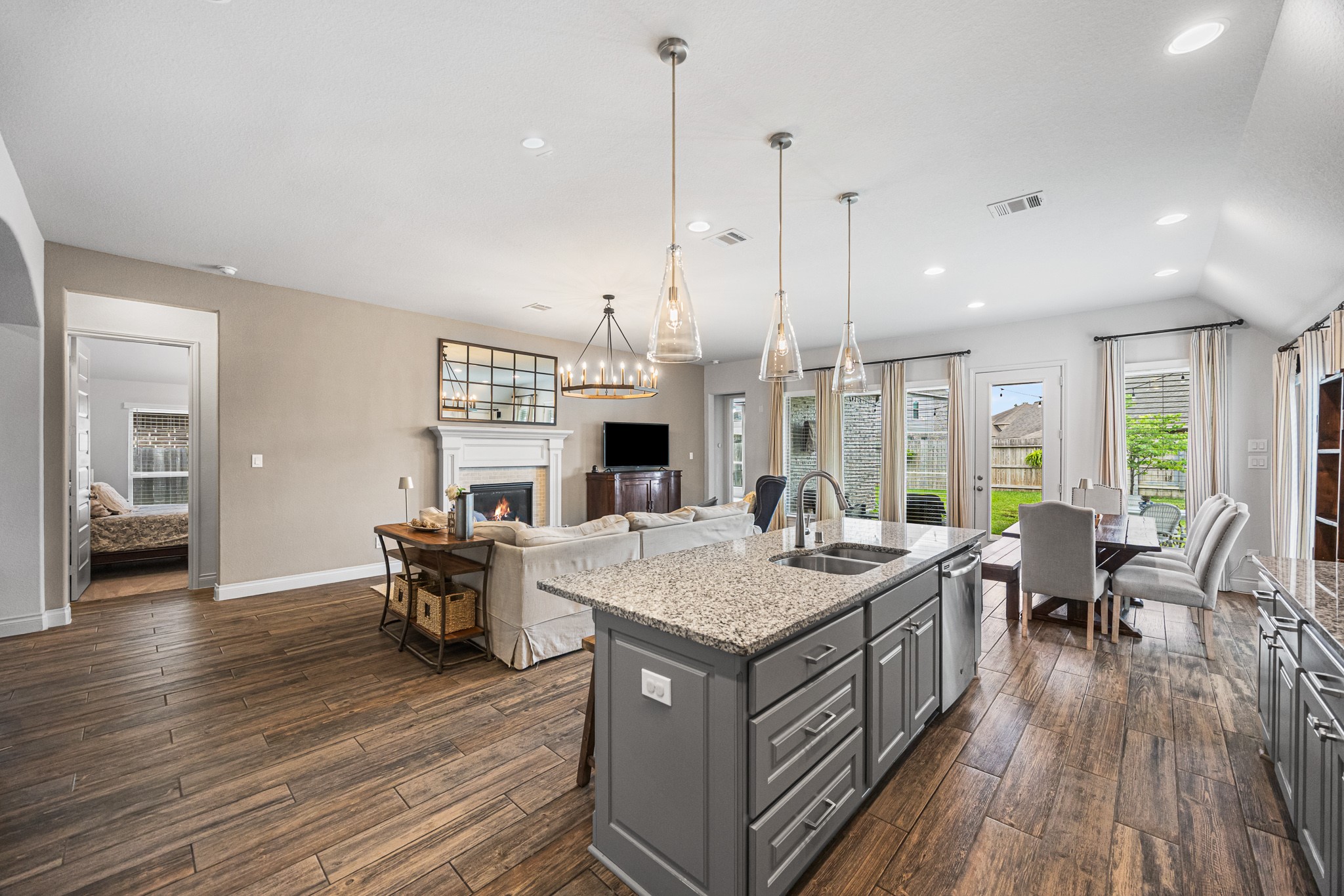 28169 Knight Peak Drive Spring, TX 77386 - Photo 6 of 33 a open kitchen with a table chairs stove and wooden floor