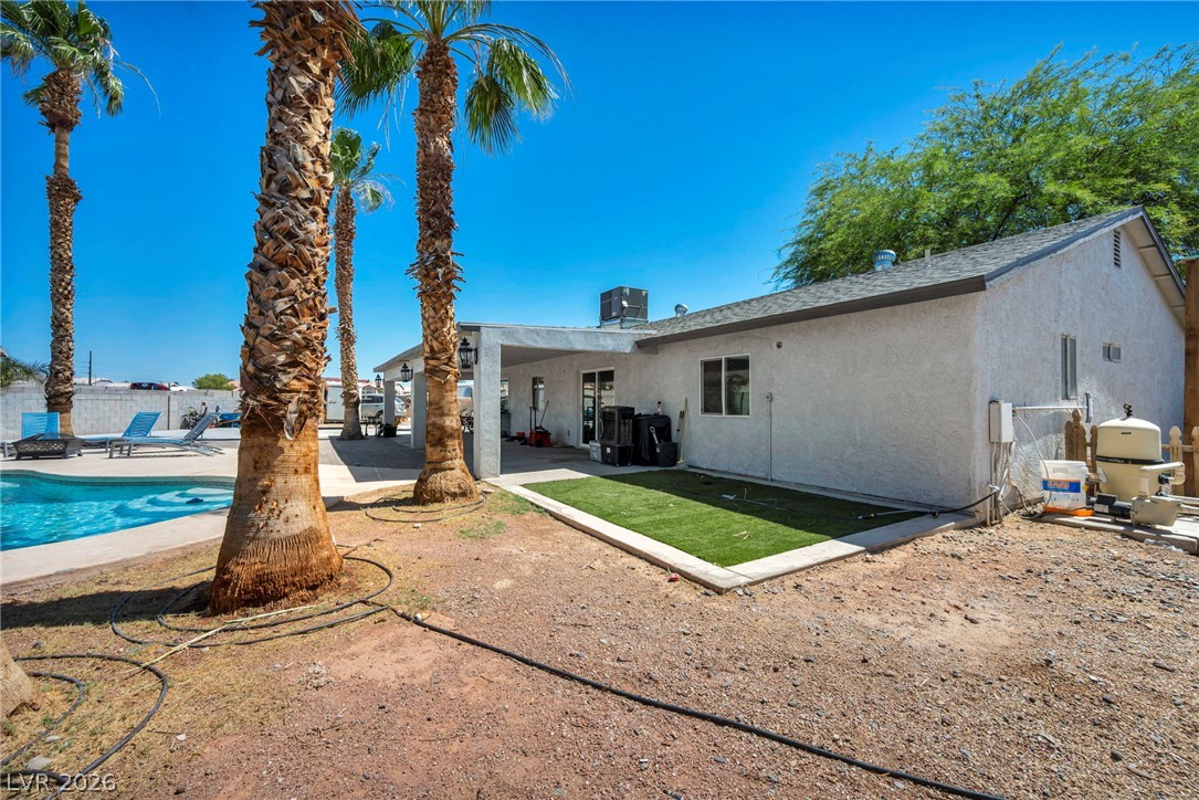 5882 Rio Tinto Way Las Vegas, NV 89110 - Photo 52 of 56 A private backyard oasis with a refreshing pool, ample patio space, and mature palm trees for relaxation.