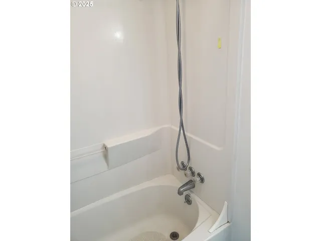a white bath tub sitting next to a white sink