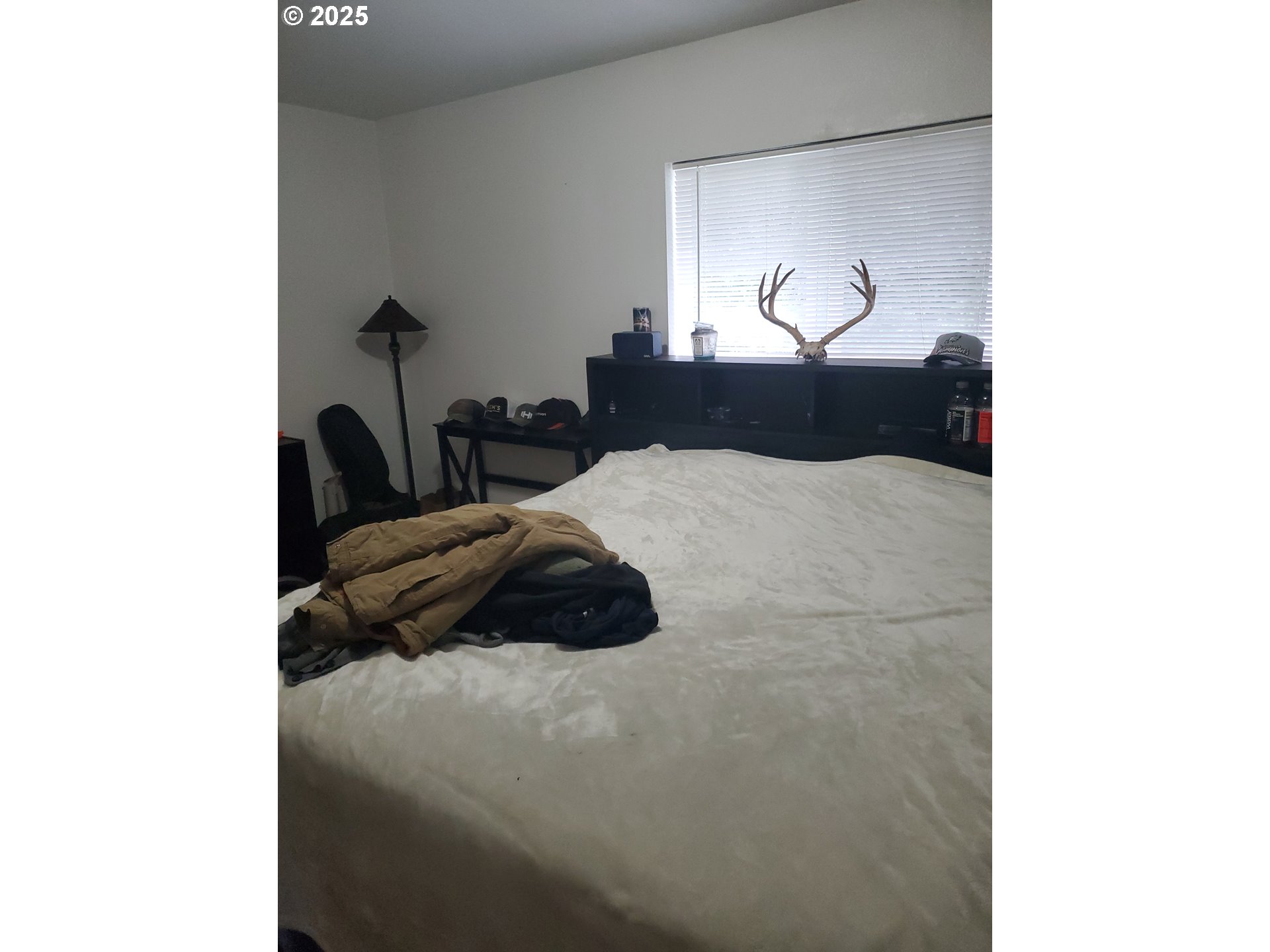 2075 Johnson Street North Bend, OR 97459 - Photo 6 of 20 a bedroom with a bed and a painting on the wall