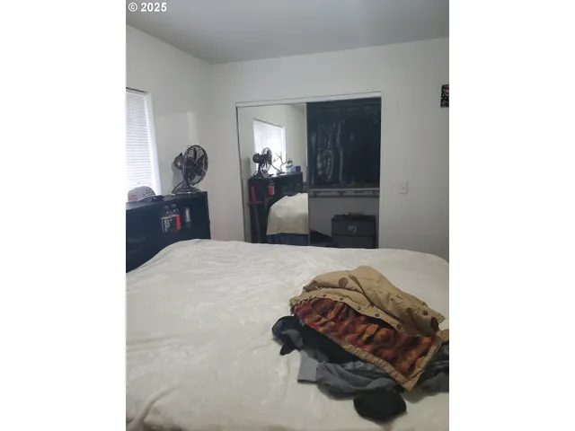 a bedroom with a bed and a mirror