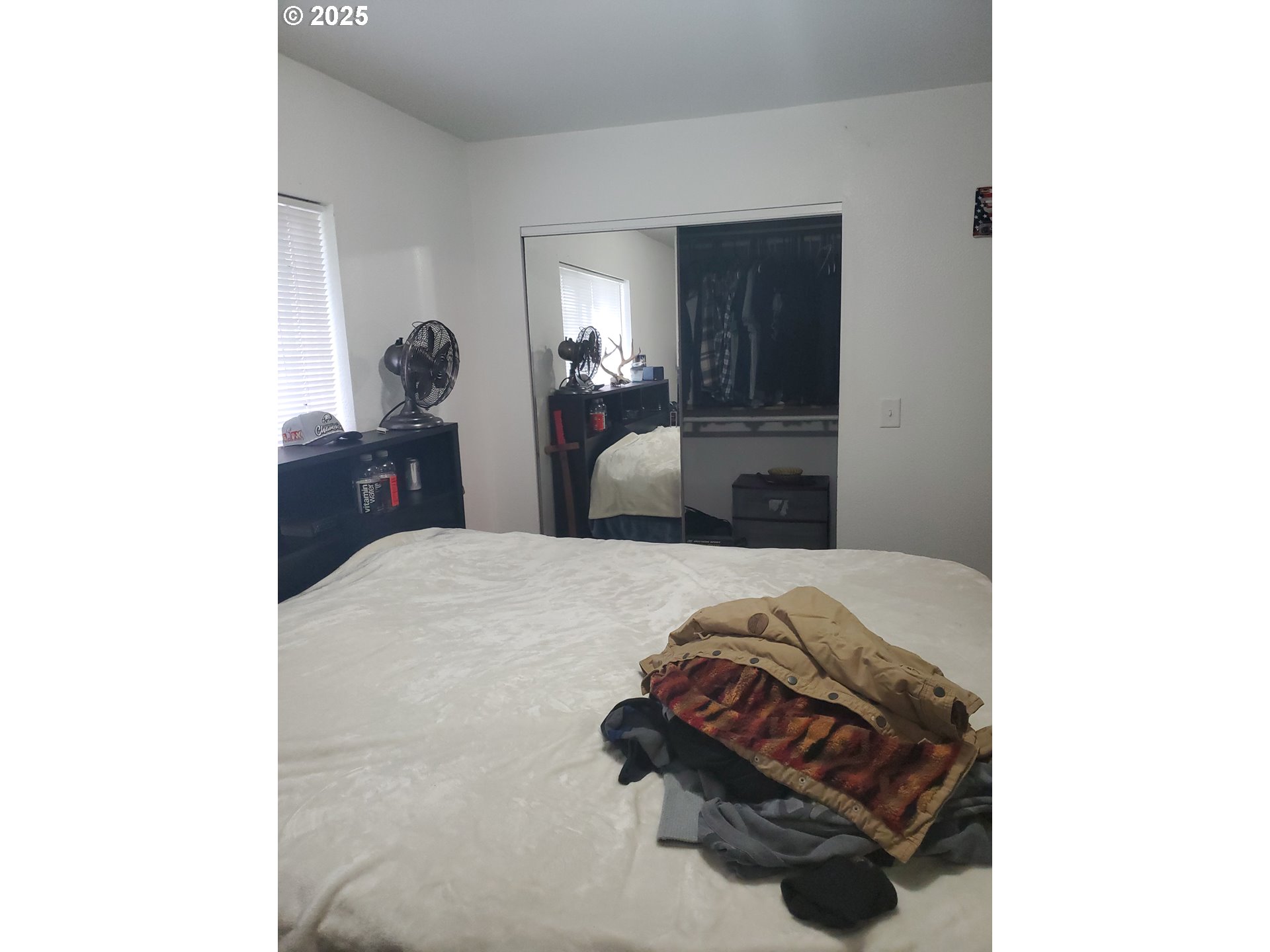 2075 Johnson Street North Bend, OR 97459 - Photo 7 of 20 a bedroom with a bed and a mirror