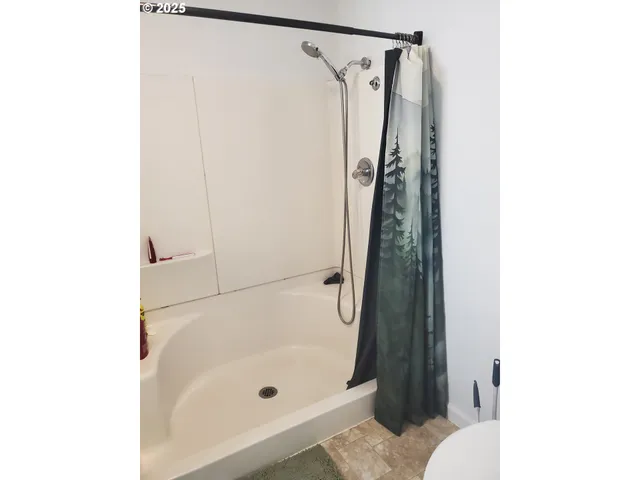 a bathroom with a bathtub and a shower