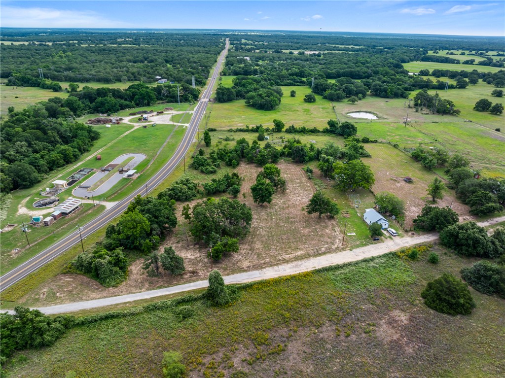 167 Signal Street Somerville, TX 77879 - Photo 5 of 12 an aerial view of green landscape with trees houses and mountain view