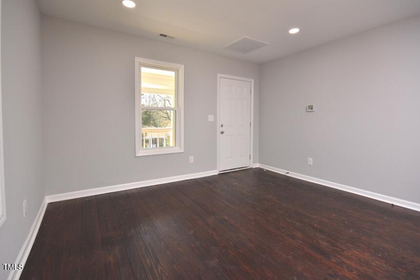1032 Cornell Street, Unit B Durham, NC 27707 - Photo 4 of 10 a view of an empty room with wooden floor and a window