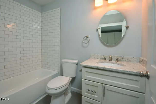 an empty room with a bathroom and a sink