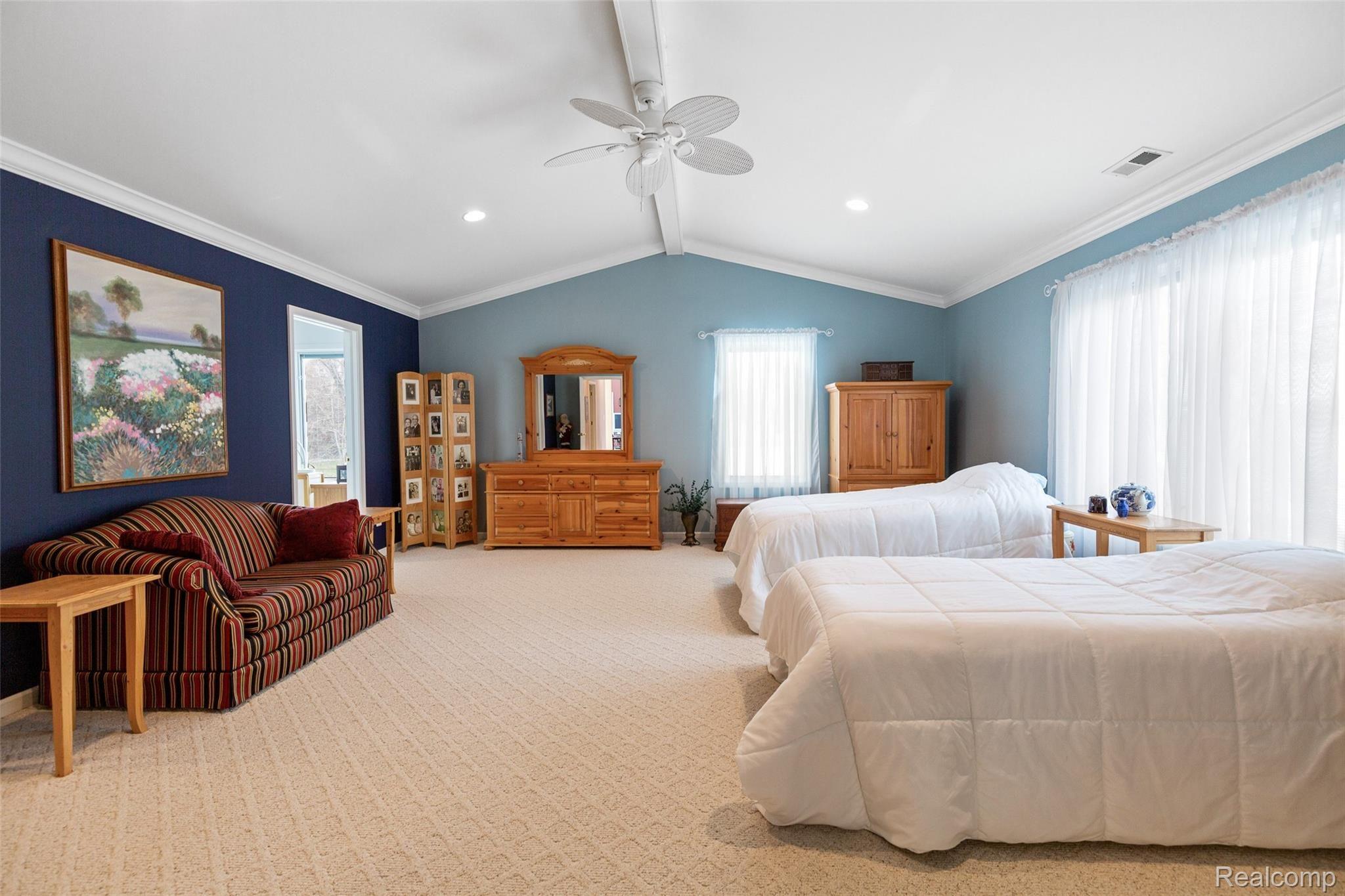 7784 Tipsico Lake Road Holly, MI 48442 - Photo 34 of 55 Inviting owner's bedroom with dual walk-in closets and lakeview