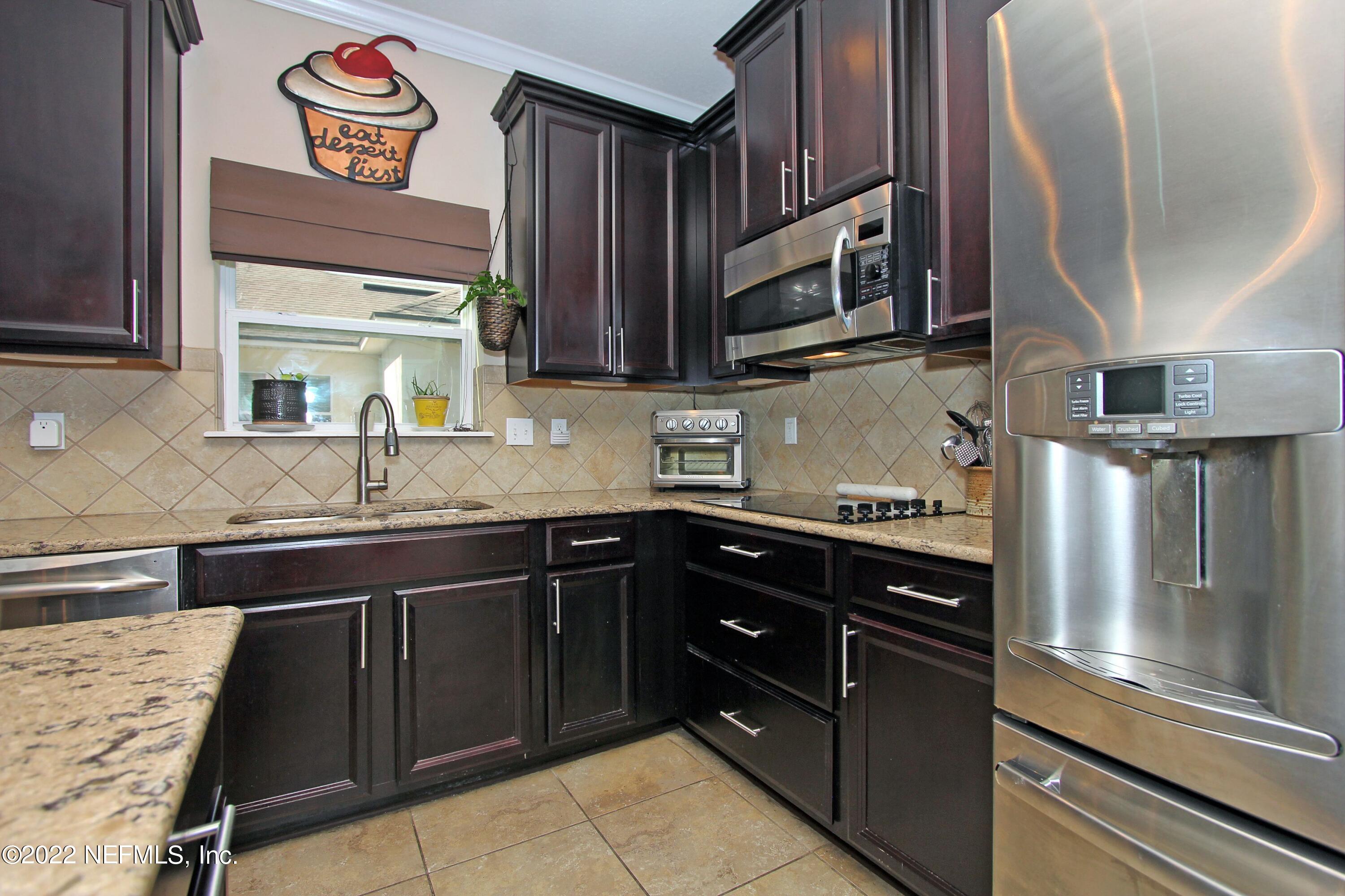 404 Paisley Place St. Johns, FL 32259 - Photo 13 of 42 a kitchen with stainless steel appliances granite countertop a refrigerator and a sink
