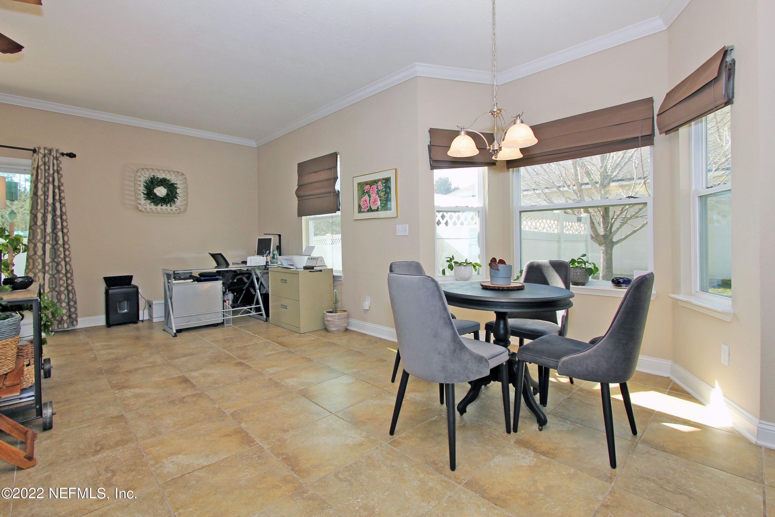 404 Paisley Place St. Johns, FL 32259 - Photo 16 of 42 a view of a dining room with furniture and a large window