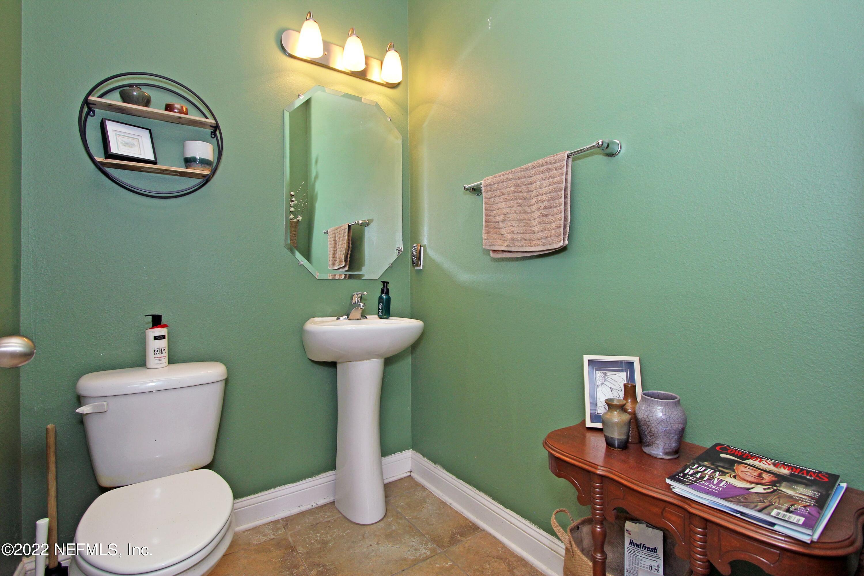 404 Paisley Place St. Johns, FL 32259 - Photo 20 of 42 a bathroom with a toilet a sink and a mirror