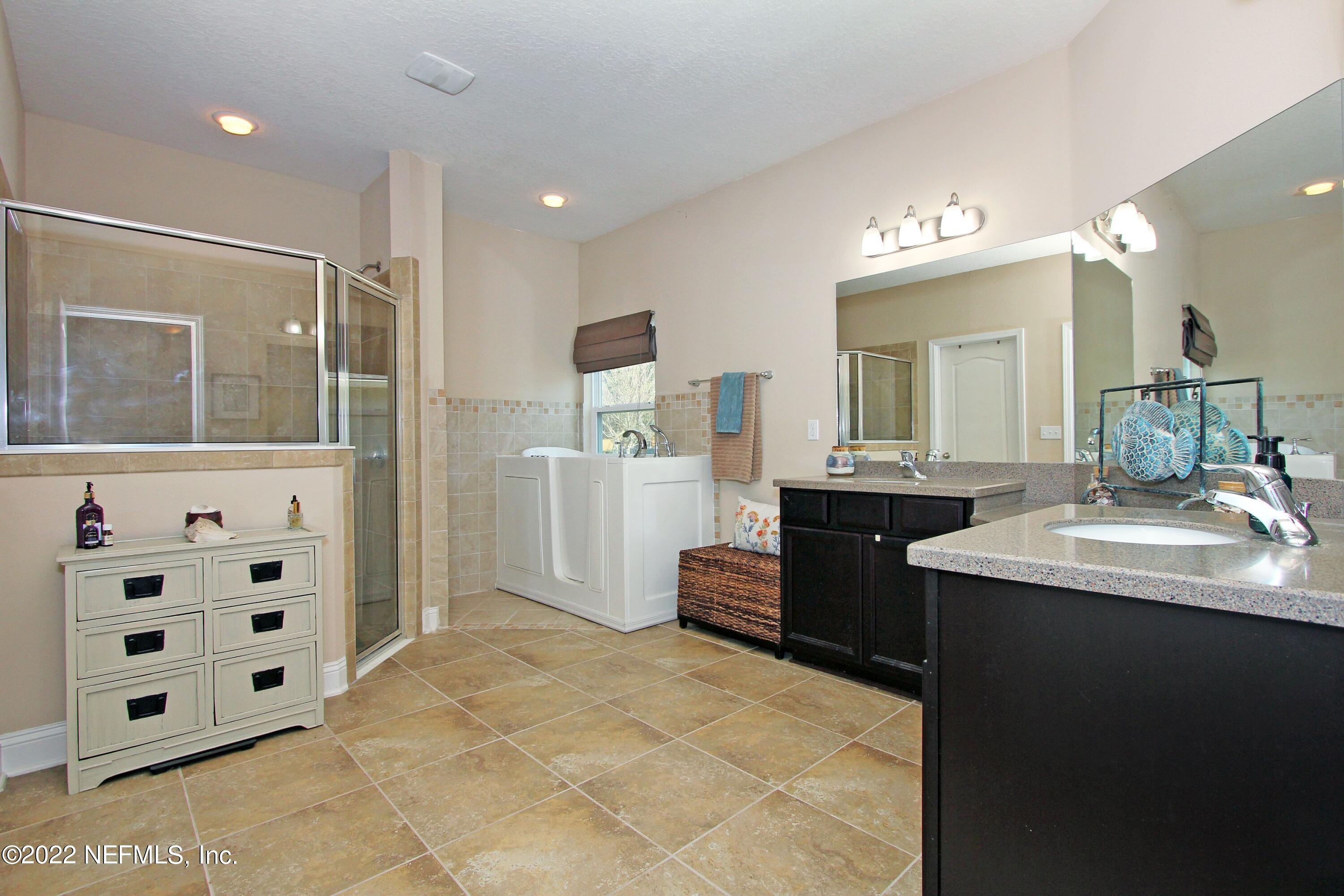 404 Paisley Place St. Johns, FL 32259 - Photo 22 of 42 a bathroom with a sink double vanity and a mirror