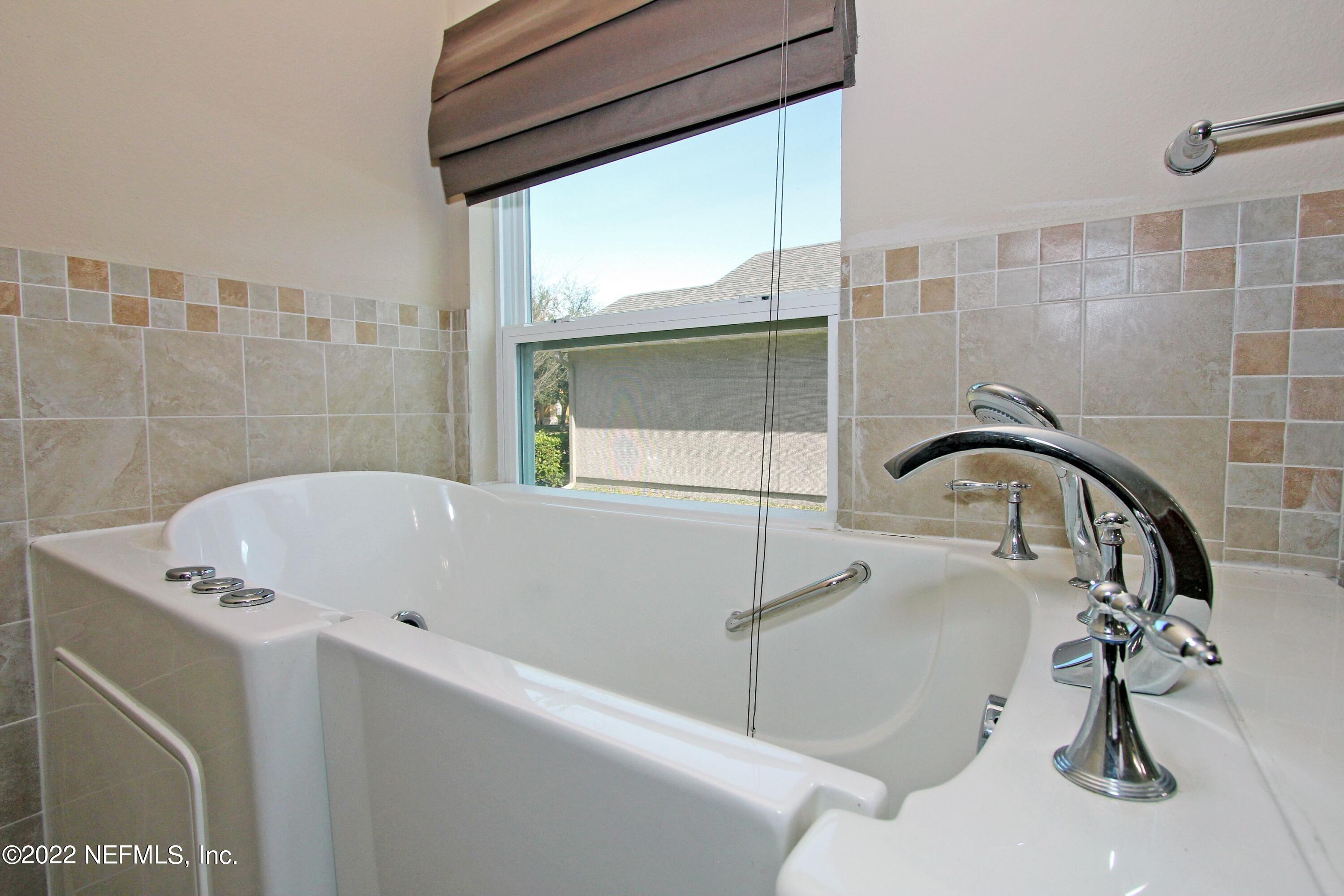 404 Paisley Place St. Johns, FL 32259 - Photo 24 of 42 a bathroom with a bathtub and a shower