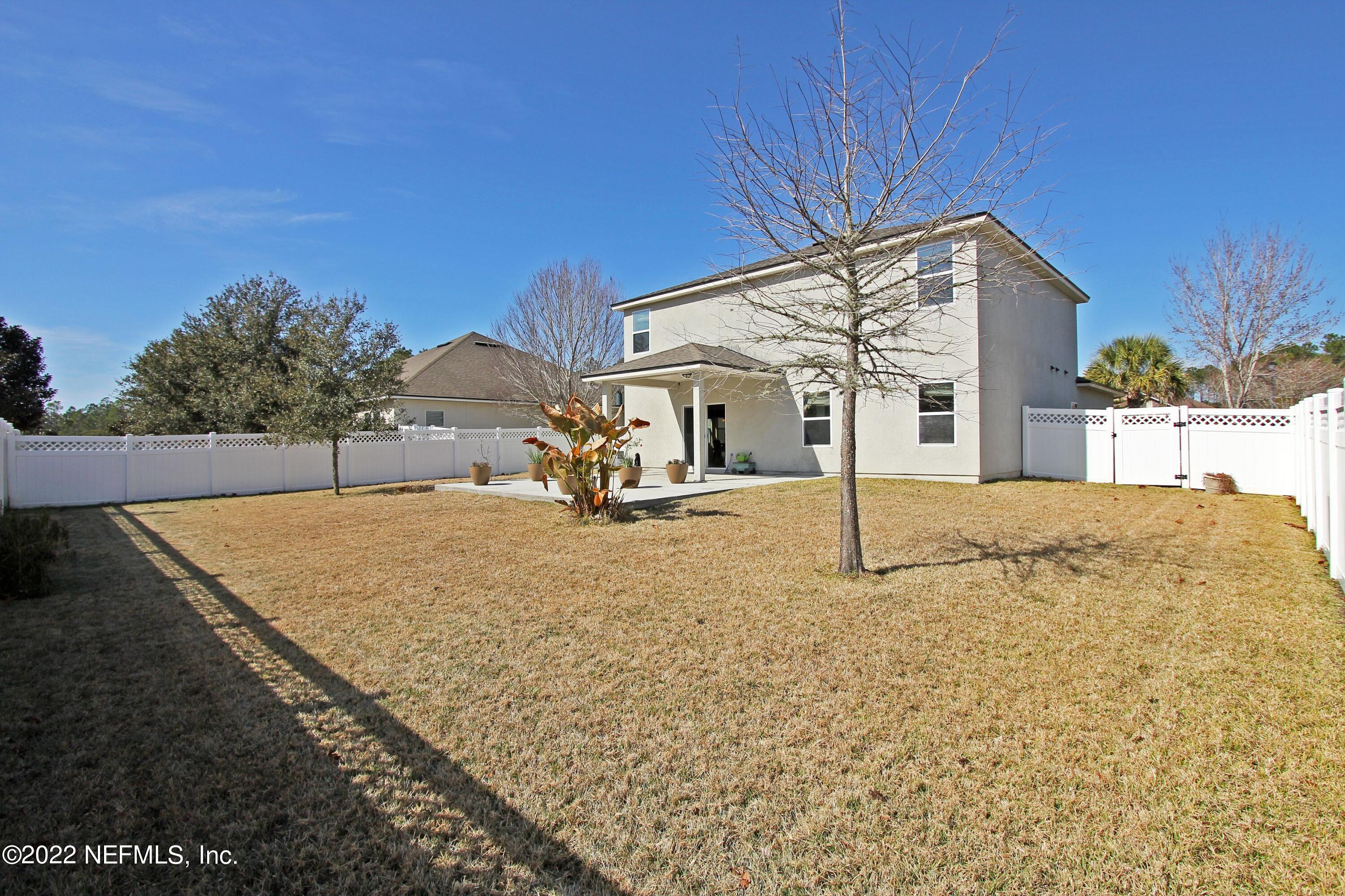 404 Paisley Place St. Johns, FL 32259 - Photo 39 of 42 a backyard of a house with table and chairs