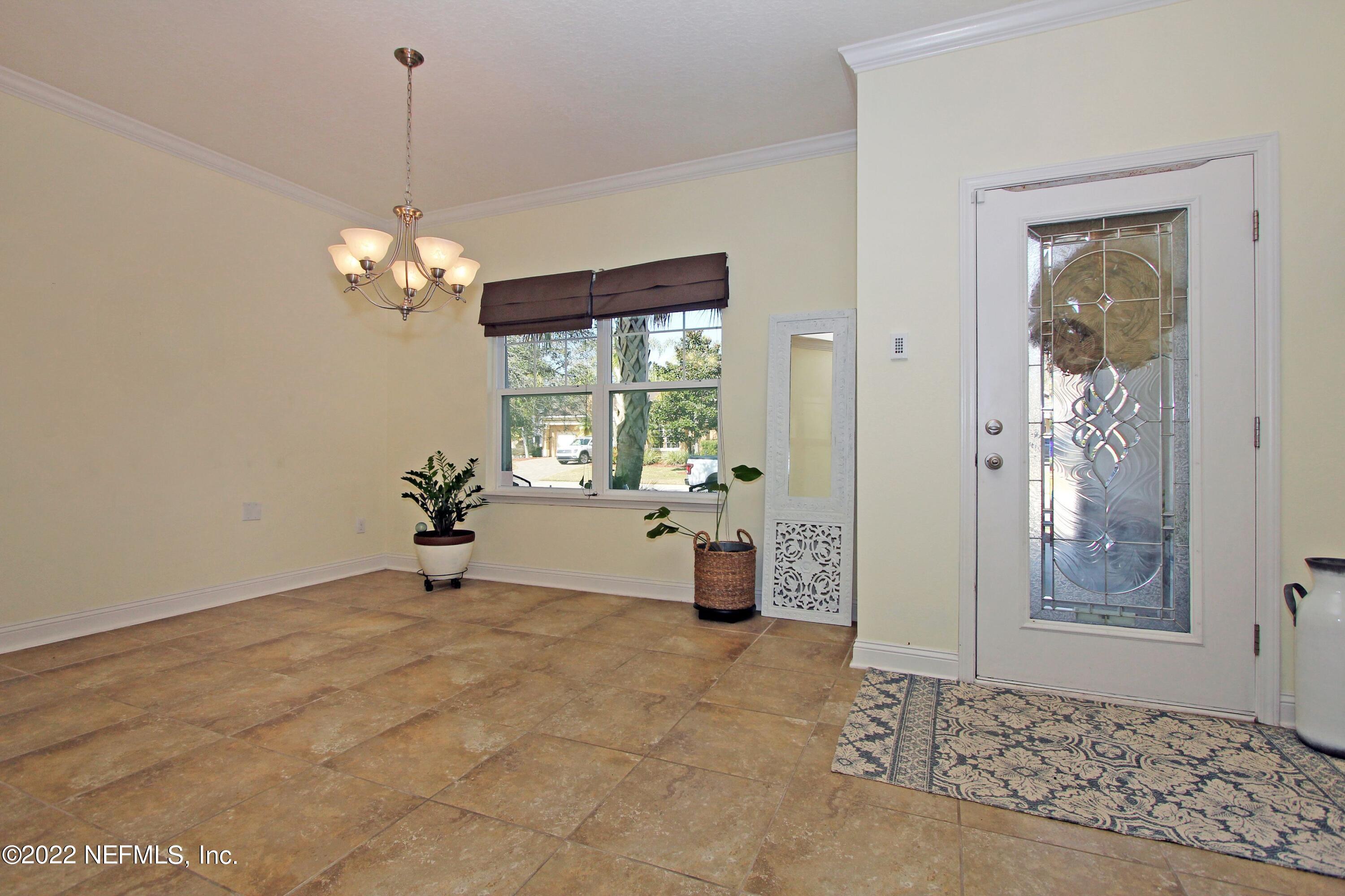 404 Paisley Place St. Johns, FL 32259 - Photo 9 of 42 a view of a livingroom with a chandelier furniture and windows