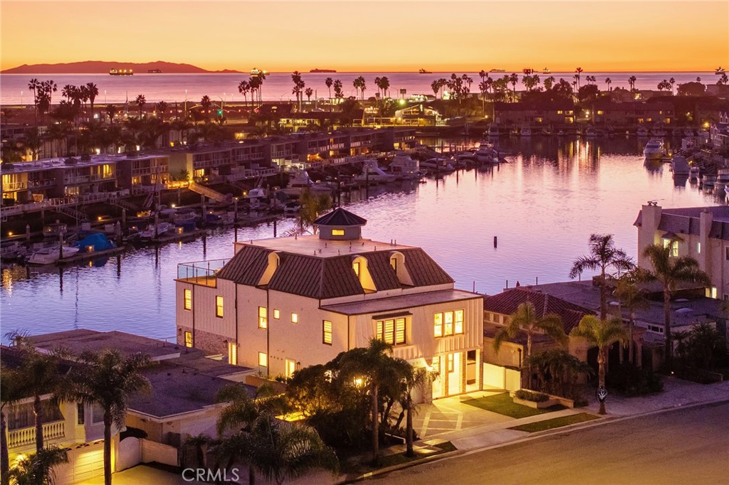 17007 Edgewater Lane Huntington Beach, CA 92649 - Photo 2 of 50 a view of a lake with a mountain in the background
