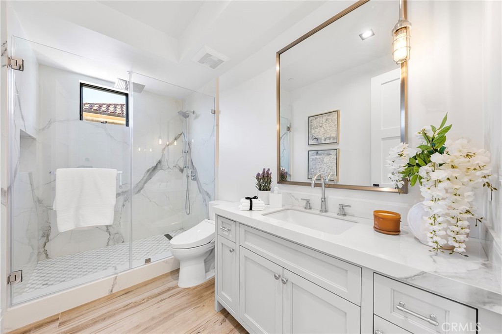 17007 Edgewater Lane Huntington Beach, CA 92649 - Photo 30 of 50 a bathroom with a sink a toilet and shower