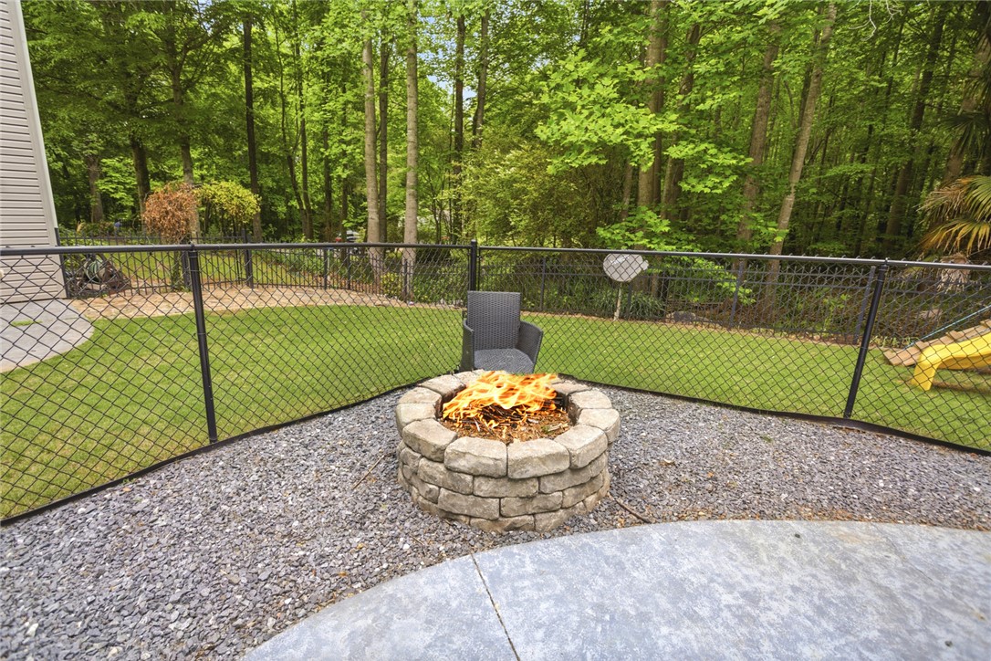 207 Devonhurst Drive Seneca, SC 29678 - Photo 43 of 50 Enjoy evening gatherings around the fire pit, surrounded by a fenced yard.
