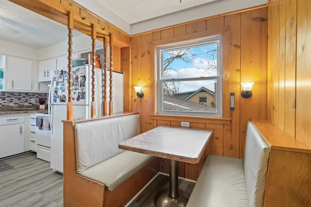 a view of a dining room with furniture window and wooden floor