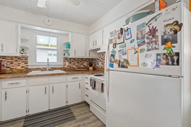 a kitchen with stainless steel appliances a sink and a refrigerator