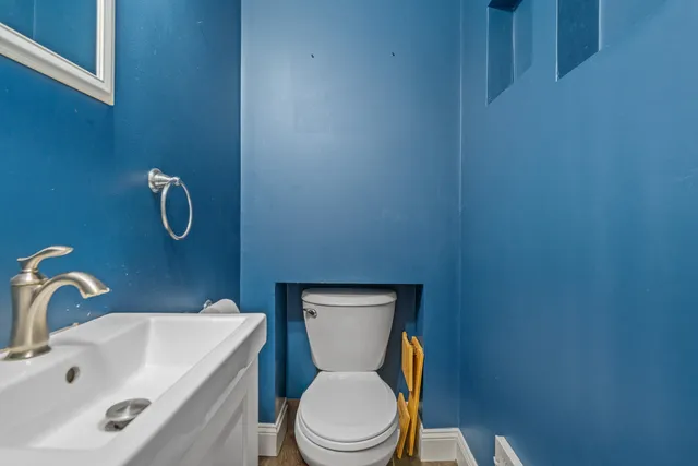 a white toilet sitting next to a bathroom sink