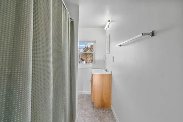 a bathroom with a shower and a sink