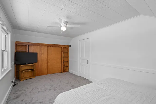 a bedroom with a bed and a television