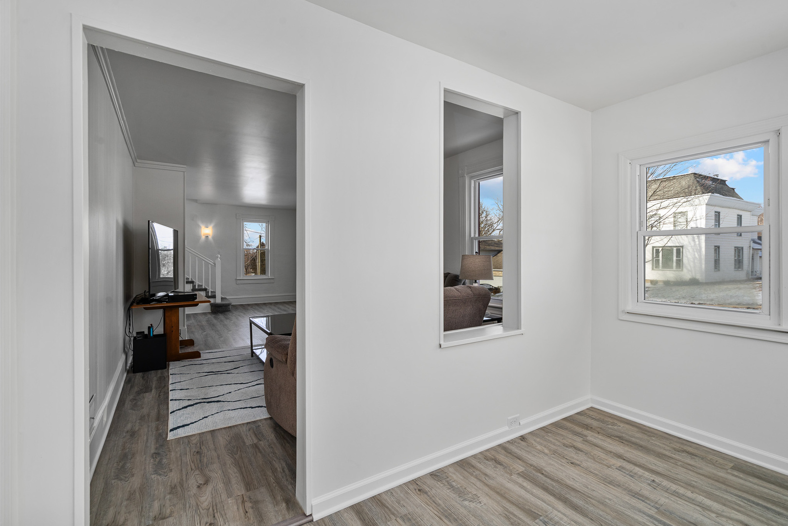501 South Hamilton Street Lockport, IL 60441 - Photo 6 of 45 a view of a hallway with wooden floor and a living room