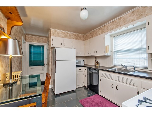 289 Wagner Road Northfield, IL 60093 - Photo 4 of 10 a kitchen with a sink appliances and cabinets