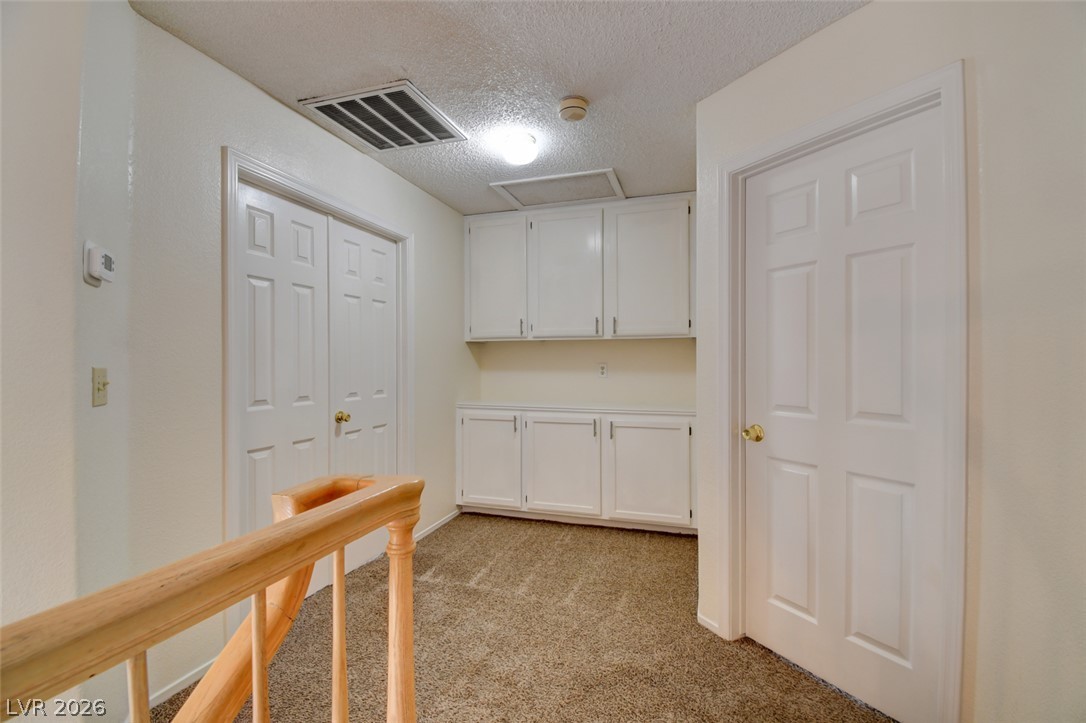 5 Tarryall Terrace Henderson, NV 89074 - Photo 30 of 44 Ample storage solutions define this practical landing, complete with built-in cabinetry and warm carpeted flooring.