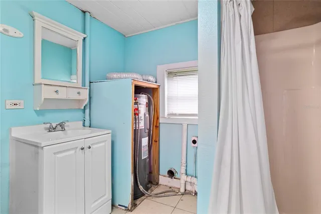 a bathroom with a sink a mirror and a shower