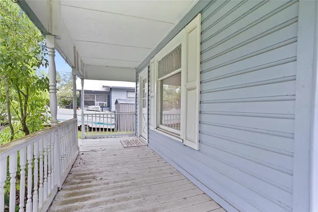 a view of a porch with wooden floor and fence