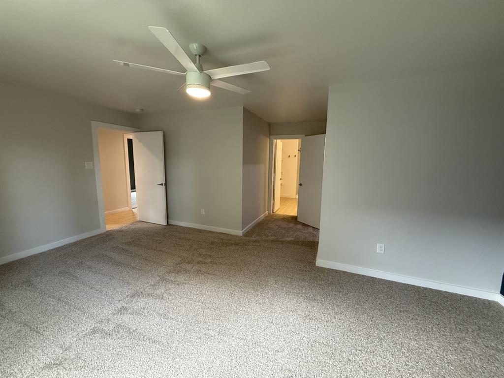 505 Thomas Street Terrell, TX 75160 - Photo 20 of 38 Spacious room featuring neutral carpeting and light gray wall paint