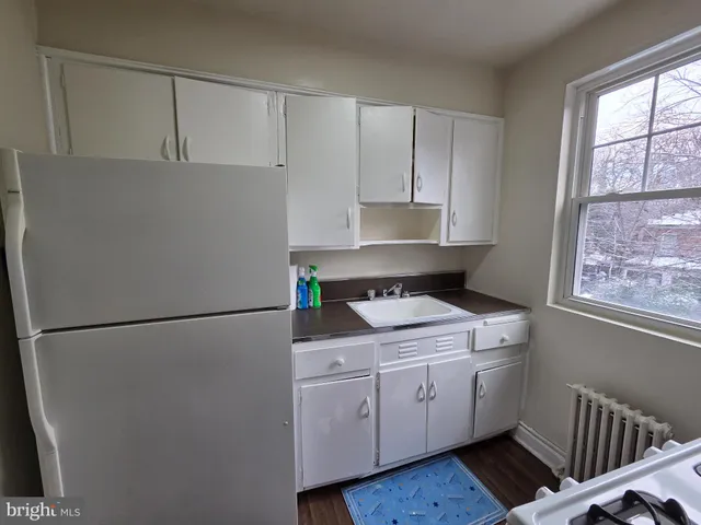 a utility room with cabinets washer and dryer