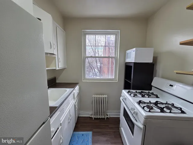a kitchen that has a sink and a stove top oven