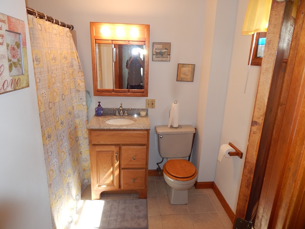 274 Athens Street Boston, MA 02127 - Photo 13 of 23 a bathroom with a toilet sink and a mirror