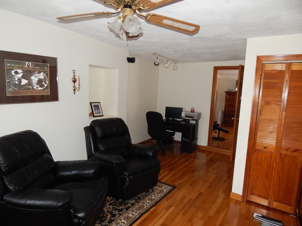 274 Athens Street Boston, MA 02127 - Photo 15 of 23 a living room with furniture and a wooden floor