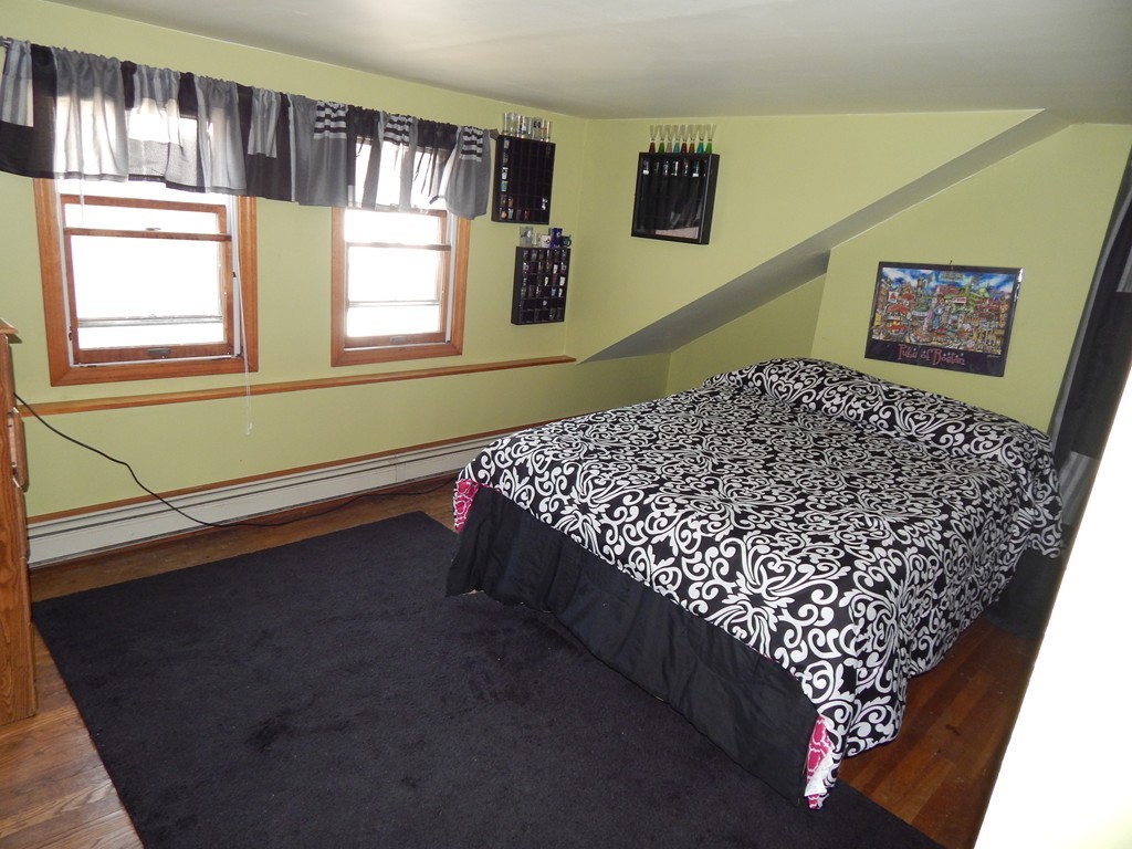 274 Athens Street Boston, MA 02127 - Photo 18 of 23 a bed sitting in a bedroom next to a window