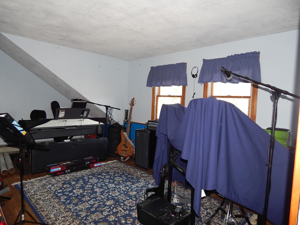 274 Athens Street Boston, MA 02127 - Photo 21 of 23 a room with furniture closet and a lamp