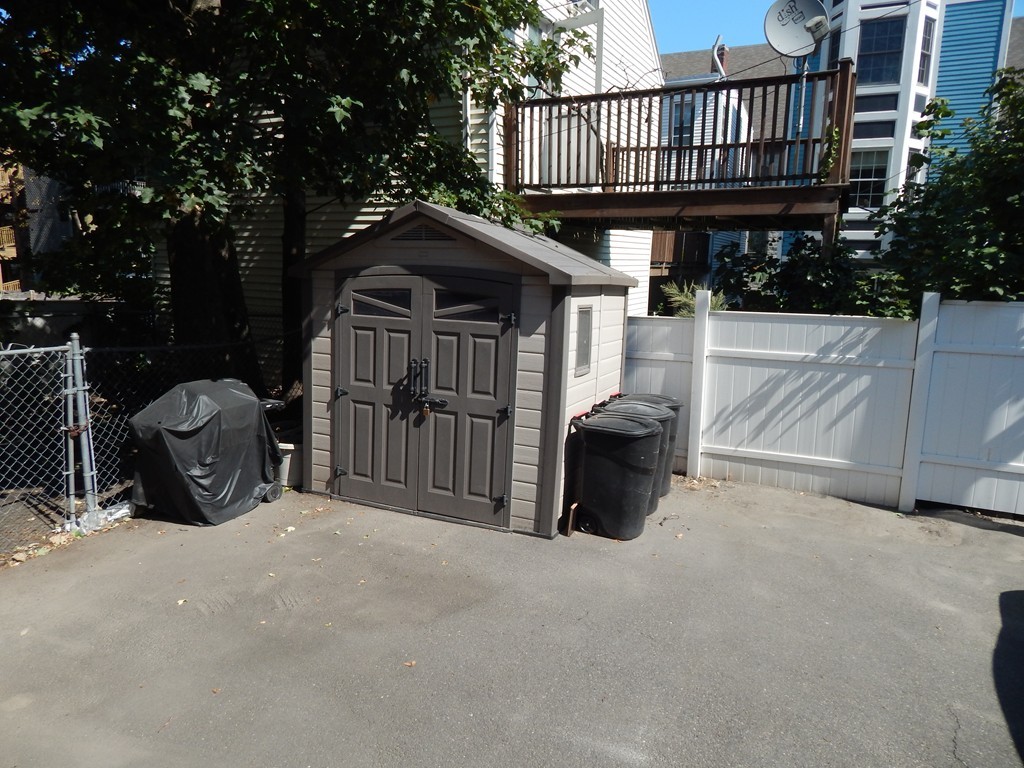 274 Athens Street Boston, MA 02127 - Photo 4 of 23 a view of a deck with wooden fence and a floor to ceiling window and wooden fence