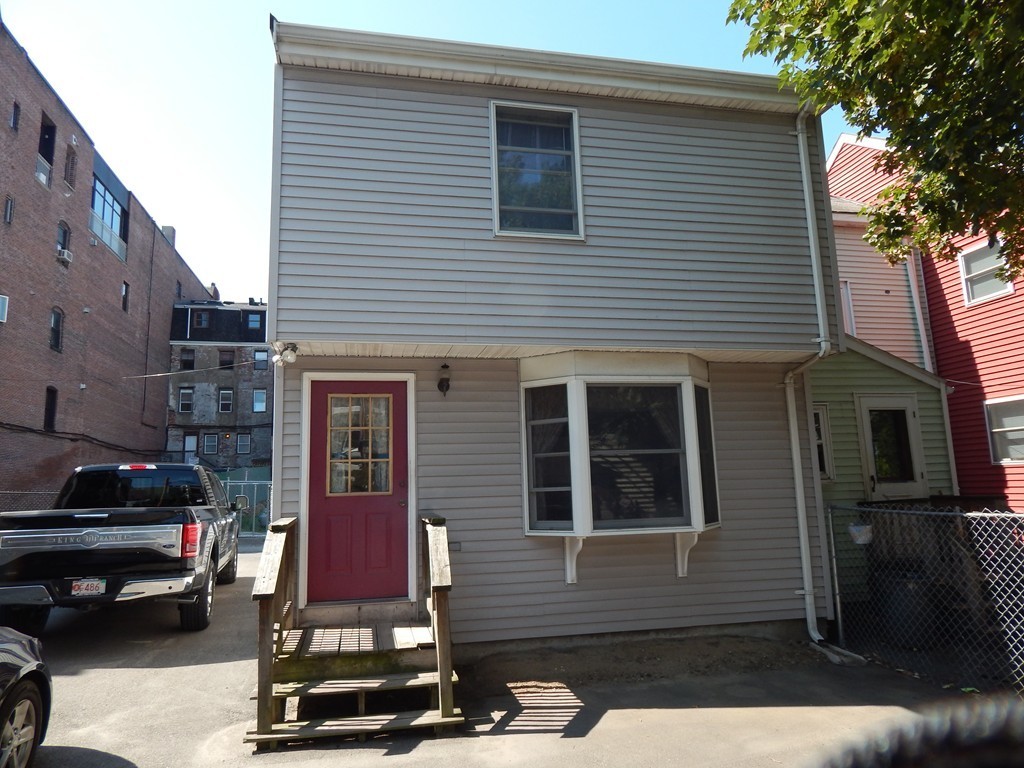 274 Athens Street Boston, MA 02127 - Photo 5 of 23 a car parked in front of a white house