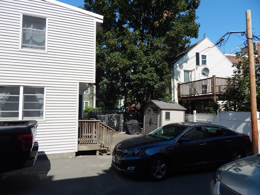 274 Athens Street Boston, MA 02127 - Photo 6 of 23 a car parked in front of a white house